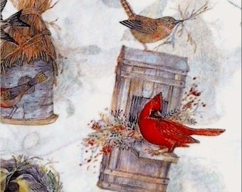 May include: A red cardinal bird perched on a wooden birdhouse with a brown roof. The birdhouse is surrounded by green foliage and a brown, straw-like nest is visible in the background.