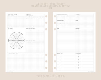 May include: A planner insert with a grid layout for monthly goal setting and review. The pages are white with black text and a radial chart. The text at the top reads "MONTH GOALS OVERVIEW & REVIEW". The bottom of the page reads "YOUR PAPER AND LINE CO."