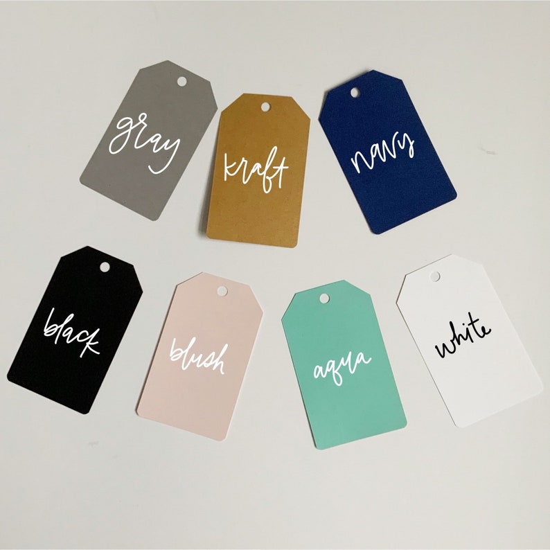 May include: Seven different color gift tags with white text. The colors are gray, kraft, navy, black, blush, aqua, and white.