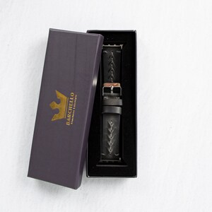 May include: A black leather watch strap with a braided design is displayed in a black box with a gold crown logo that says "Barchello Timeless Elegance".
