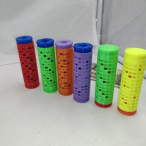 May include: Six colorful plastic hair rollers with a grid pattern. The rollers are red, green, orange, purple, lime green, and yellow.