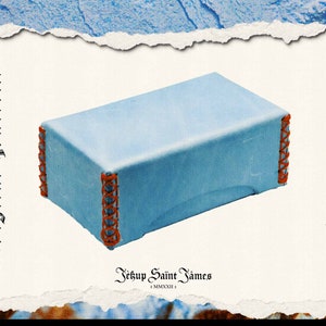 May include: A light blue box with orange stitching around the edges. The box is sitting on a white background. The text "Leather Croft" is on the right side of the image and the text "Digital Pattern" is on the left side of the image. The text "JéSup Saint James" is at the bottom of the image.