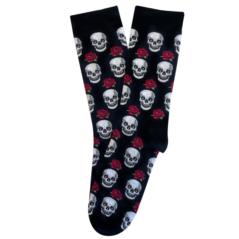 May include: Black socks with a repeating pattern of white skulls and red roses. The socks are made of a soft material and are designed to be worn on the feet. The socks are a gothic or alternative style.