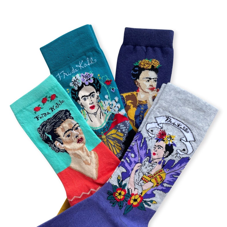 May include: Four pairs of colorful socks with a Frida Kahlo theme. Each sock features a different portrait of Frida Kahlo with flowers and other details. The socks are made of a soft, comfortable material and are perfect for adding a touch of personality to any outfit.