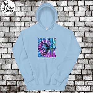 May include: A light blue tie-dye hoodie with a black silhouette of a volleyball player spiking the ball. The text "VOLLEYBALL" is printed in purple and blue letters.