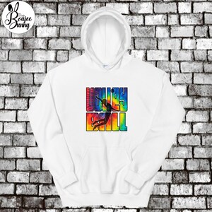 May include: White hoodie with a tie-dye design featuring a silhouette of a volleyball player spiking the ball. The text "VOLLEYBALL" is printed in black letters on the hoodie.