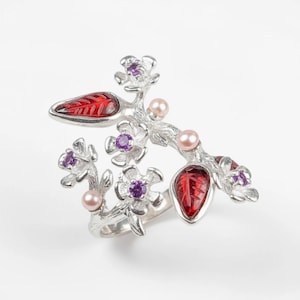 October birthstone floral ring featuring raw pink gemstone and organic branch design.