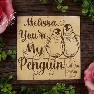 May include: Wooden puzzle with a penguin couple and the text "Melissa, You're My Penguin Will You Marry Me?"