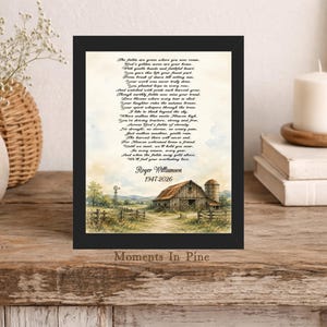 May include: A framed memorial print featuring a poem titled The fields are green where you now roam, dedicated to Roger Williamson 1947-2026. The artwork depicts a rustic barn, a silo, and a windmill in a rural landscape with watercolor tones.