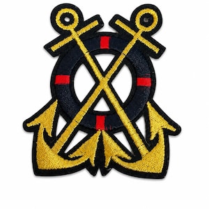 May include: An embroidered patch featuring two crossed gold anchors layered over a dark navy blue life ring. The life ring is accented with four distinct red stripes positioned at the top, bottom, left, and right sides. The entire design is outlined in black thread.