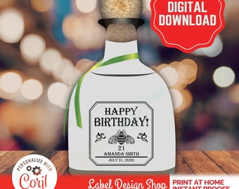 May include: A white liquor bottle label design featuring a cork stopper and a green ribbon. The label text reads HAPPY BIRTHDAY! with a bee illustration, the number 21, the name AMANDA SMITH, and the date JULY 31, 2020. A red badge says DIGITAL DOWNLOAD.
