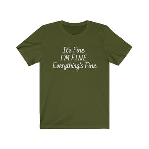 May include: A green t-shirt with the text "It's Fine I'M FINE Everything's Fine" printed in white.