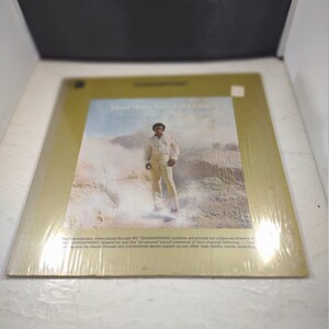 May include: A vintage vinyl record album cover featuring a man in a white shirt and jeans standing in a desert landscape. The album title is "Don't Make Me Over" and the text on the bottom of the cover reads "This Columbia disc, when played through SO QUADRAPHONIC systems, will provide the unique experience of QUADRAPHONIC separation and the "all-around sound presence of four-channel listening. This disc may also be played through any conventional stereo system as any other high fidelity stereo recording."