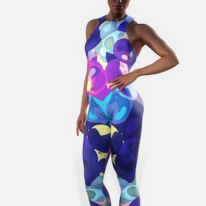 May include: A blue, purple and yellow patterned one-piece jumpsuit with a scoop neck and sleeveless design.