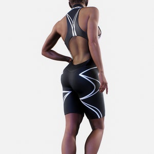 May include: Black and white athletic one-piece suit with a cutout back and white geometric design.