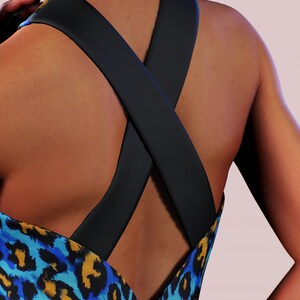 May include: A blue and yellow leopard print dress with a black criss-cross strap detail at the back.