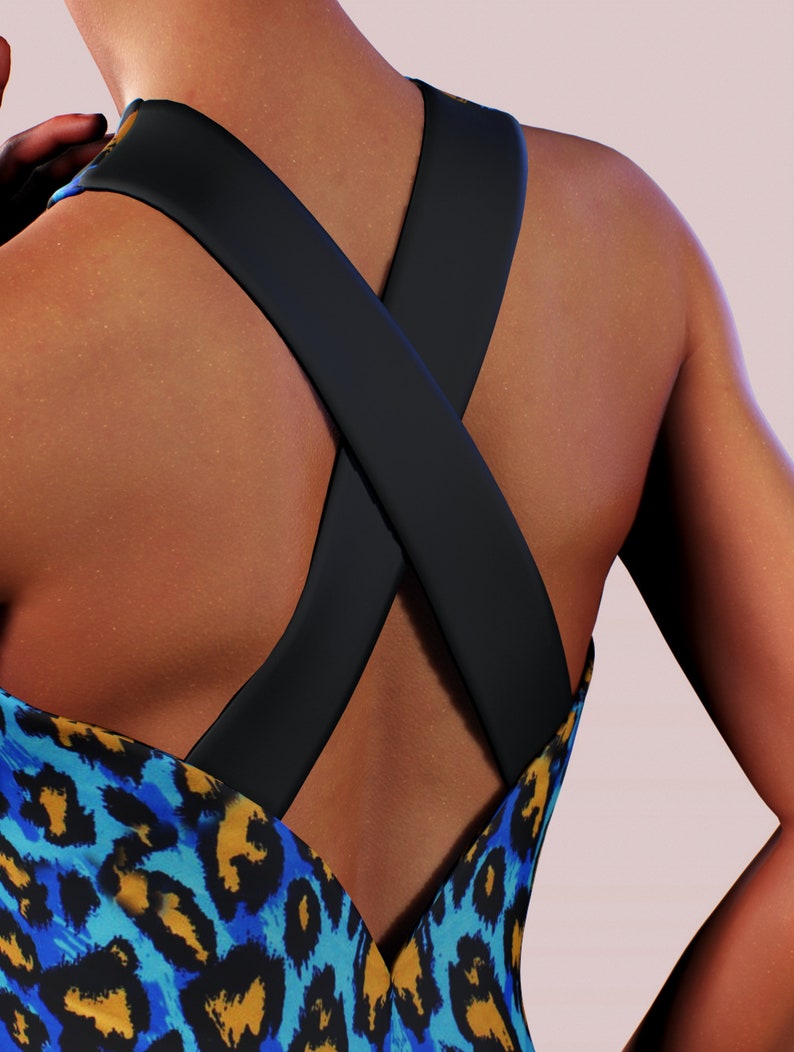 May include: A blue and yellow leopard print dress with a black criss-cross strap detail at the back.