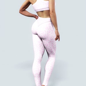 May include: White leggings with a pink leopard print pattern. The leggings are form-fitting and have a high waist.