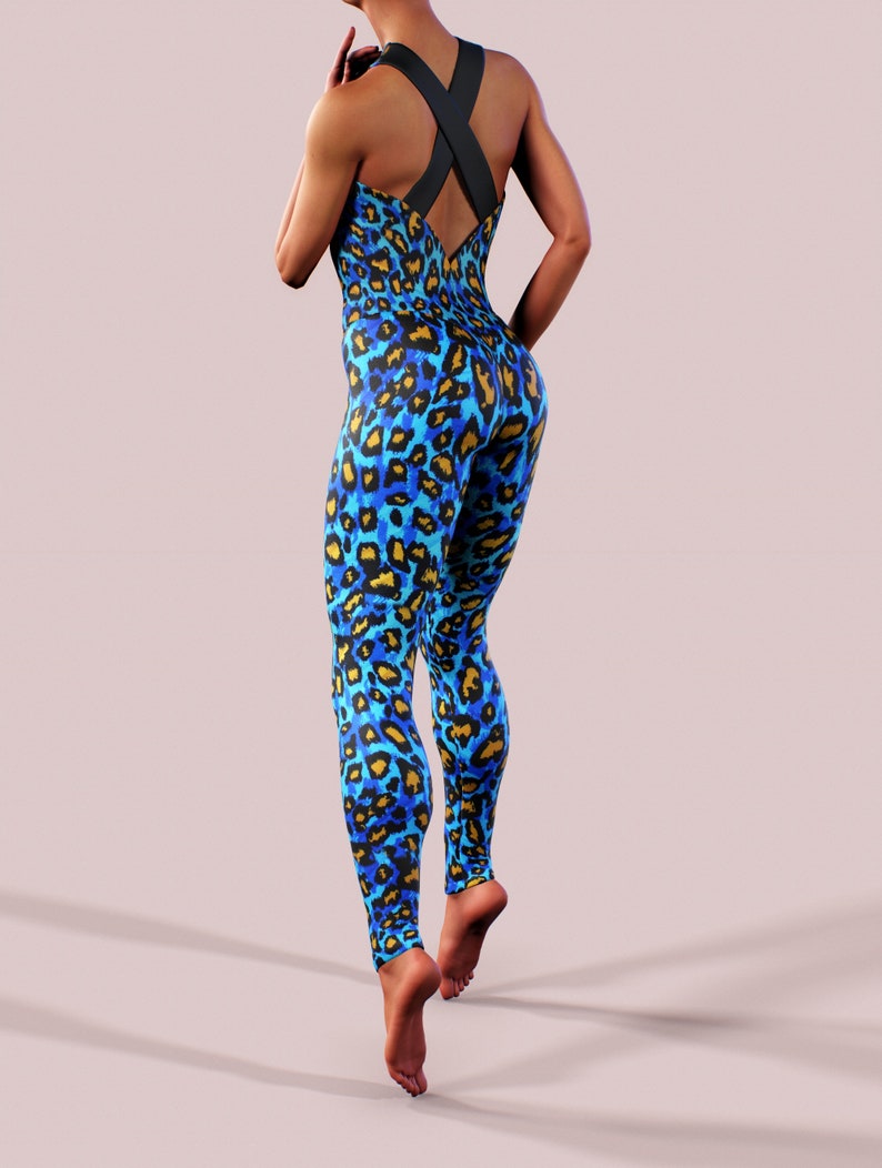 May include: A blue and yellow leopard print jumpsuit with a black criss-cross strap back.