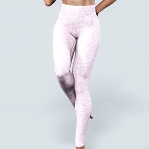 May include: White leggings with a pink leopard print pattern. The leggings have a high waist and a fitted silhouette.