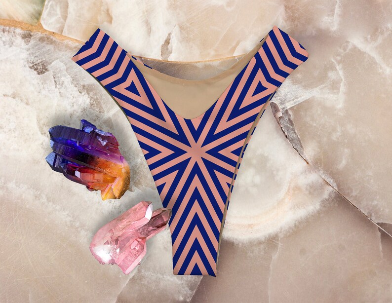 May include: A pair of pink and navy blue underwear with a geometric pattern. The underwear is made of a soft, stretchy fabric and has a high-cut leg.