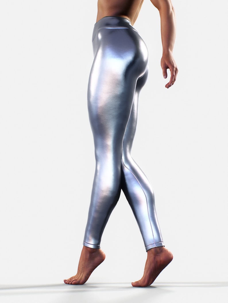 May include: High-waisted leggings in a metallic silver finish with a smooth, reflective surface. These form-fitting leggings feature a sleek, liquid-like appearance that contours to the legs, extending from the waist down to the ankles.