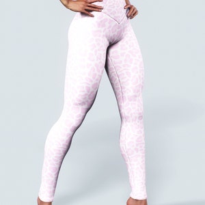 May include: White leggings with a pink leopard print pattern. The leggings have a high waist and a V-shaped seam at the crotch.