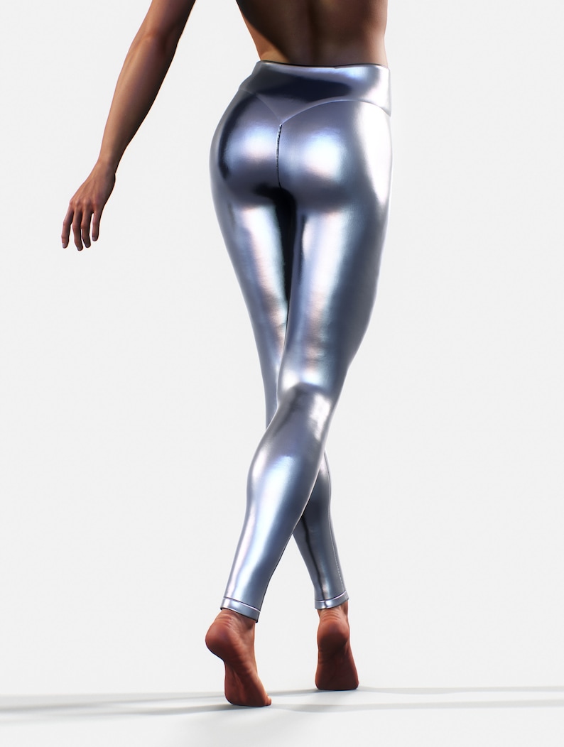 May include: High-waisted leggings in a metallic silver finish with a smooth, reflective surface. The leggings feature a fitted silhouette that extends to the ankles, showcasing a sleek, shiny texture that catches the light across the fabric.