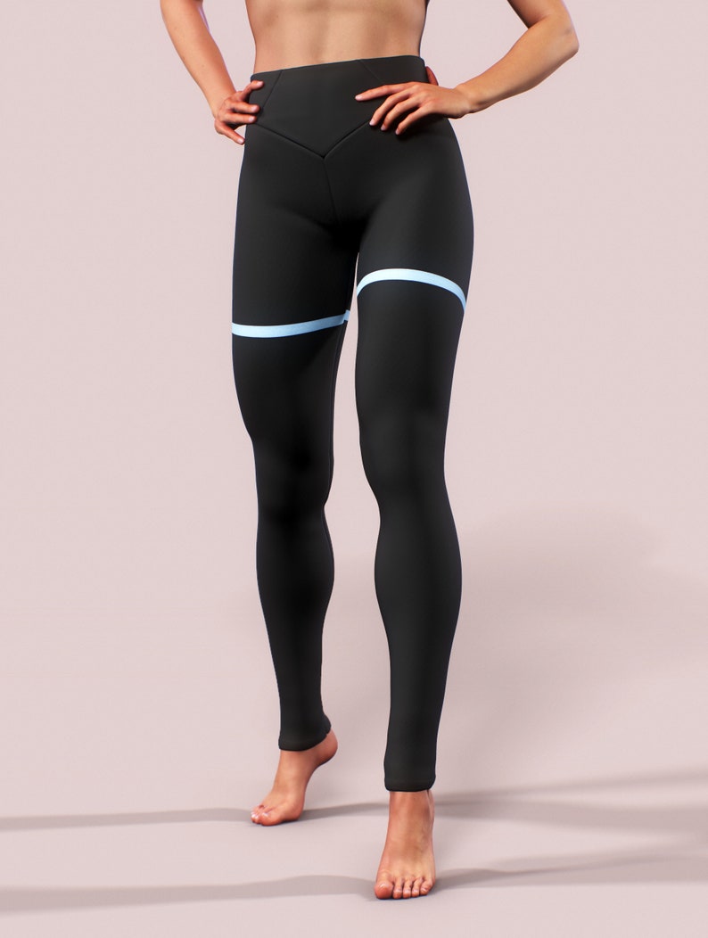 Pu&ograve; includere: Leggings neri a vita alta con un dettaglio a striscia orizzontale azzurra sulla coscia. I leggings hanno un design aderente e sono realizzati in un tessuto liscio e opaco. I leggings sono progettati per attivit&agrave; sportive.