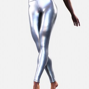 May include: High-waisted leggings in a metallic silver finish with a smooth, reflective surface. These form-fitting leggings feature a wide waistband and a sleek, streamlined design that extends down to the ankles with clean, stitched hems.