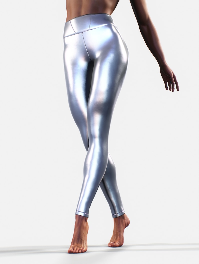 May include: High-waisted leggings in a metallic silver finish with a smooth, reflective surface. These form-fitting leggings feature a wide waistband and a sleek, streamlined design that extends down to the ankles with clean, stitched hems.