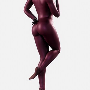 May include: A burgundy full-body catsuit with a high collar and long sleeves. The catsuit is form-fitting and has a shiny appearance. The person is wearing black gloves and is barefoot.