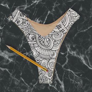May include: Black and white patterned bikini top with a detailed design of musical notes, swirls, and other abstract shapes.