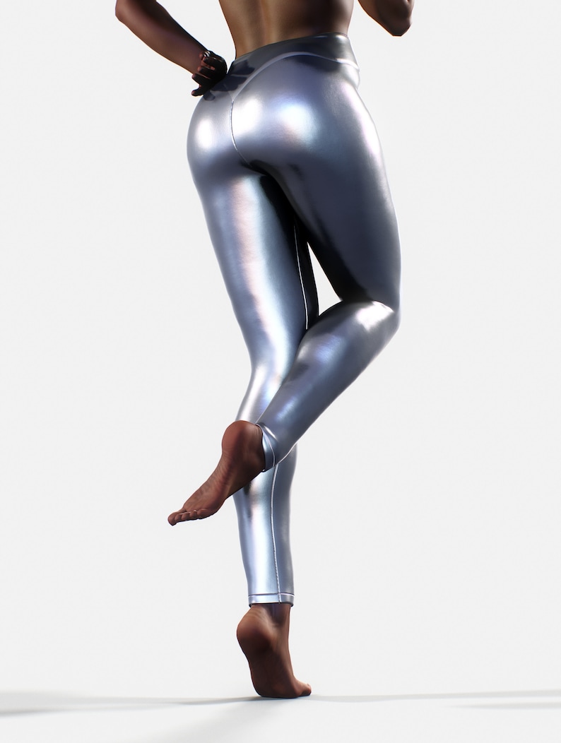 May include: High-waisted leggings in a metallic silver finish with a smooth, reflective surface. The leggings feature a fitted silhouette that extends to the ankles, showcasing a sleek, shiny texture that catches the light across the fabric.