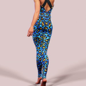 May include: A blue and gold leopard print jumpsuit with a black criss-cross strap back.