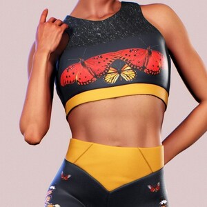 May include: Black and yellow athletic leggings with a butterfly print. The leggings have a high waist and a yellow waistband. The butterflies are red, orange, and yellow.