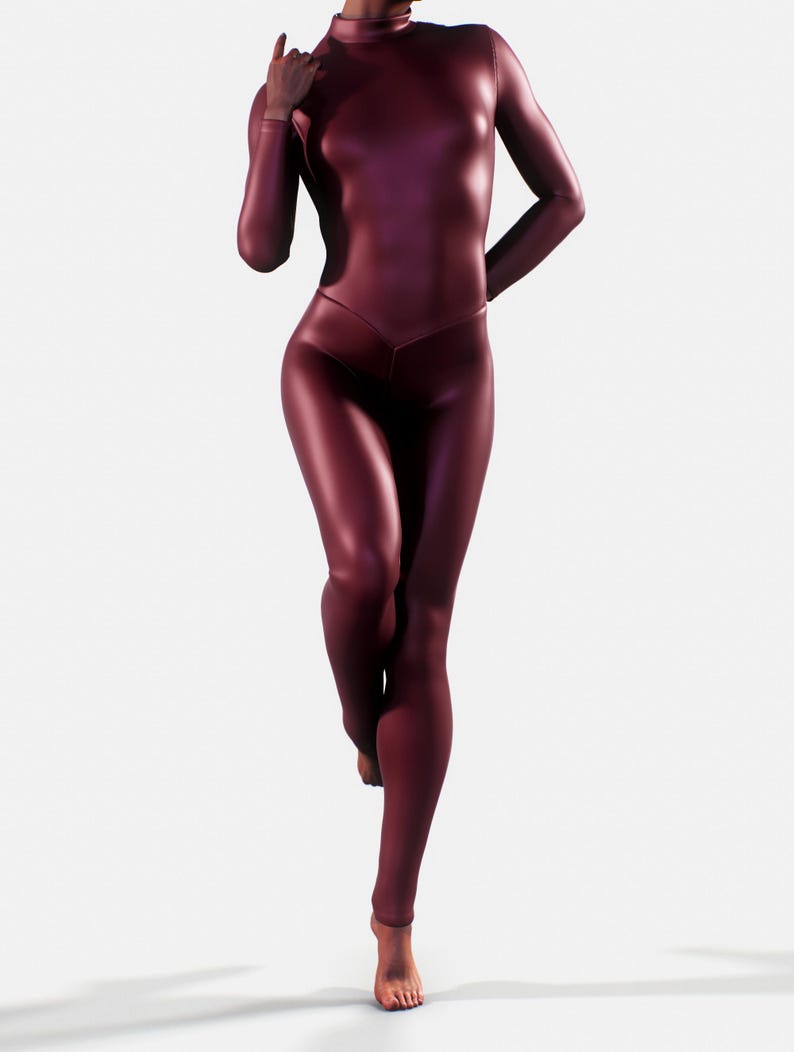 May include: A burgundy-colored, full-body catsuit with long sleeves and a high neckline. The form-fitting garment has a V-shaped waistline and covers the legs. The person is barefoot and standing on one leg.