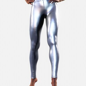 May include: High-waisted leggings in a metallic silver finish with a smooth, reflective surface. These form-fitting leggings feature a wide waistband and a sleek, seamless appearance that extends down to the ankles, showcasing a bright, polished look.