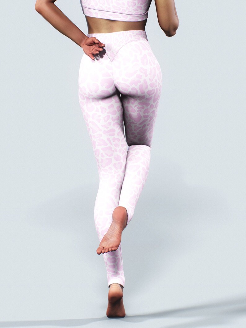 May include: A pair of pink leggings with a white leopard print pattern. The leggings are fitted and have a high waist.