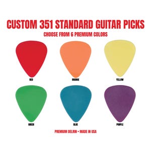 May include: Six 351 standard guitar picks in red, orange, yellow, green, blue, and purple. The text reads: CUSTOM 351 STANDARD GUITAR PICKS, CHOOSE FROM 6 PREMIUM COLOURS, RED, ORANGE, YELLOW, GREEN, BLUE, PURPLE, PREMIUM DELRIN, MADE IN USA.