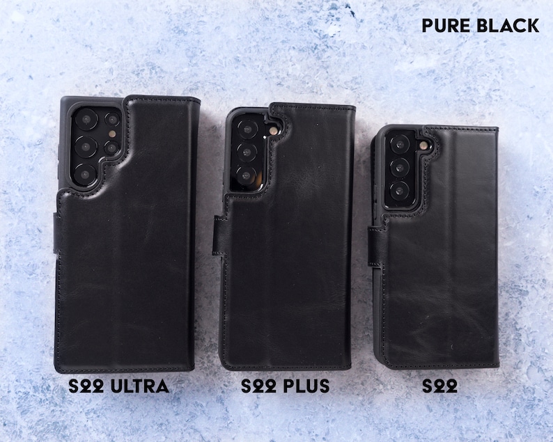 May include: Three black leather phone cases for the Samsung Galaxy S22 Ultra, S22 Plus, and S22. The cases are all closed and have a flap that covers the screen. The text "PURE BLACK" is at the top of the image. The text "S22 ULTRA", "S22 PLUS", and "S22" are at the bottom of the image.