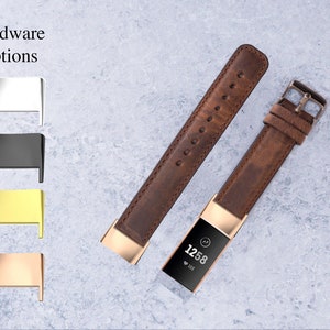 May include: A brown leather watch band with gold hardware. The band is shown with a fitness tracker with a rose gold finish. The image also shows a selection of hardware options: silver, black, gold, and rose gold.