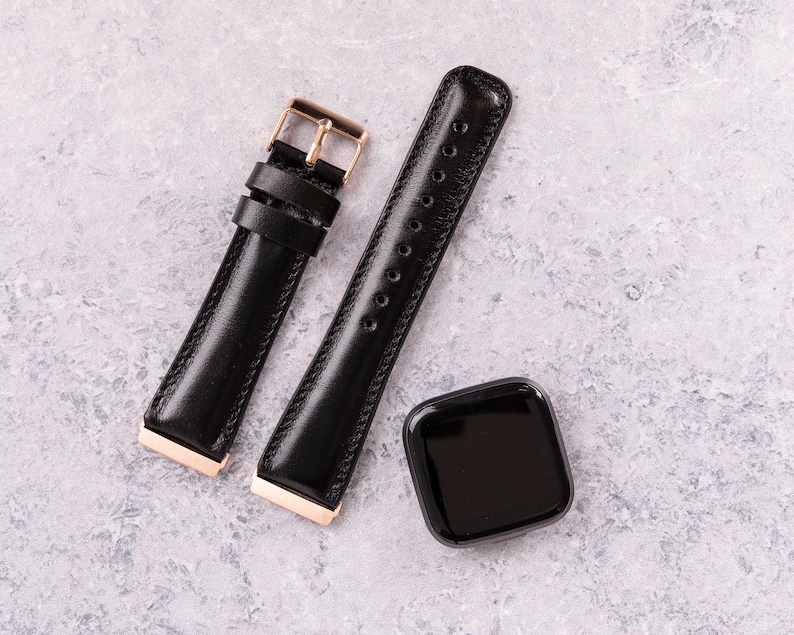May include: Two black leather watch bands with gold hardware. One band has a buckle closure and the other has a pin and loop closure.