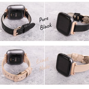 Op de afbeelding: Twee Fitbit Versa 3 smartwatches met verschillende leren bandjes. De smartwatch links heeft een beige bandje en de smartwatch rechts heeft een zwart bandje. De tekst "Pure Black" is zichtbaar boven de smartwatch rechts en de tekst "Exact Nude" is zichtbaar boven de smartwatch links.