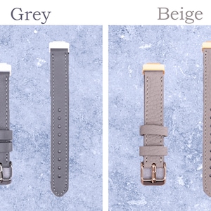 May include: Two watch straps, one grey and one beige, are displayed against a light blue background. The grey strap has a silver buckle and white accents. The beige strap has a gold buckle and gold accents. The word "Grey" and "Beige" are above each strap.