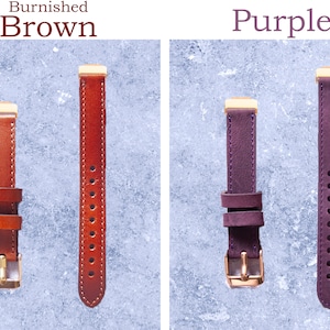 May include: Two watch straps, one burnished brown and one purple, are displayed against a light blue background. The brown strap has a gold buckle and a series of holes. The purple strap also has a gold buckle and a series of holes.