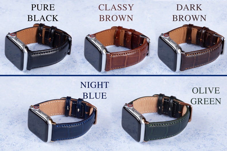 K&ouml;nnte beinhalten: Apple Watch Armb&auml;nder in verschiedenen Farben, darunter reines Schwarz, edles Braun, Dunkelbraun, Nachtblau und Olivgr&uuml;n. Die Armb&auml;nder sind aus Leder und haben ein Krokodilmuster.