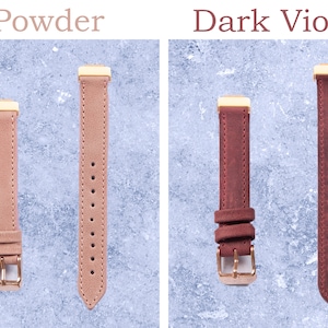 May include: Two watch straps in the image. One is powder pink, the other is dark violet. Both have gold-colored metal hardware and are made of a suede-like material. The text "Powder" and "Dark Violet" are above the straps.