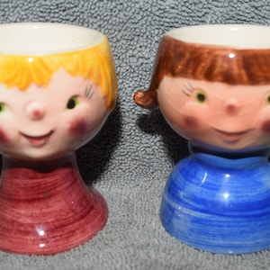 Goebel/West Germany Egg Cups-Circa 1968.  Blonde Boy #191A Brunette Pig-tailed Girl #191B