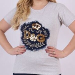 May include: A gray short-sleeved t-shirt with a gold and blue sequined D&G logo design.